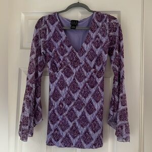 Beautiful blouse, bell sleeves, tie back, never worn.
